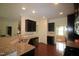 Kitchen with granite countertops, stainless steel appliances, dark cabinets and hardwood flooring at 1549 Lily Creek Dr, Cary, NC 27518