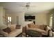 Spacious living room featuring neutral colors, plush sofas, and a view into the kitchen at 1549 Lily Creek Dr, Cary, NC 27518