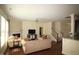 Cozy living room featuring a fireplace, comfortable seating, hardwood floors and staircase at 1549 Lily Creek Dr, Cary, NC 27518