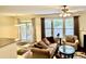 Bright living room that boasts a fireplace, lots of natural light, and access to a covered back porch at 1549 Lily Creek Dr, Cary, NC 27518