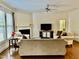 Well-lit living room with hardwood floors, fireplace, and plush furnishings at 1549 Lily Creek Dr, Cary, NC 27518