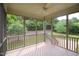 Relaxing screened porch with ceiling fan, offering an inviting outdoor space surrounded by lush greenery at 1549 Lily Creek Dr, Cary, NC 27518