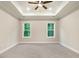 Bedroom featuring a tray ceiling, recessed lighting, and two large windows at 157 Gumtop Dr, Zebulon, NC 27597