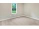 Bright bedroom with plush carpet and a window overlooking the yard at 157 Gumtop Dr, Zebulon, NC 27597
