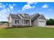 Beautiful new construction home featuring a gray color scheme, well-manicured lawn, and attached two-car garage at 157 Gumtop Dr, Zebulon, NC 27597
