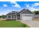Charming new construction home featuring a gray color scheme, landscaped yard, and attached two-car garage at 157 Gumtop Dr, Zebulon, NC 27597