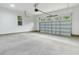 Spacious two-car garage with concrete floor and an automatic door at 157 Gumtop Dr, Zebulon, NC 27597