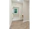 Hallway view to bathroom with tile flooring and natural light from the window at 157 Gumtop Dr, Zebulon, NC 27597