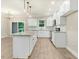 Well-lit kitchen boasts white cabinets, stainless steel appliances, and granite countertops at 157 Gumtop Dr, Zebulon, NC 27597