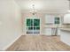 Eat-in kitchen features white cabinetry, stainless steel appliances, granite countertops, and wood floors at 157 Gumtop Dr, Zebulon, NC 27597
