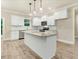 Modern kitchen with white cabinets, granite countertops, stainless steel appliances, and center island at 157 Gumtop Dr, Zebulon, NC 27597