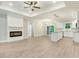 Spacious living room with a fireplace, wood floors, and white trim at 157 Gumtop Dr, Zebulon, NC 27597