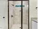 Modern tiled shower with glass doors, a shower niche, and adjustable shower head at 157 Gumtop Dr, Zebulon, NC 27597
