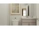 Cozy half bathroom featuring a neutral vanity with a brushed nickel faucet, and a patterned rug on the wall at 1601 Goldfinch Perch Ln, Knightdale, NC 27545