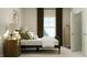 Cozy bedroom with a black metal bed frame, wooden nightstands, and natural light coming through the window at 1601 Goldfinch Perch Ln, Knightdale, NC 27545