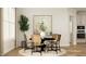 Sunlit dining area featuring modern chairs around a round table with stylish decor and hardwood flooring at 1601 Goldfinch Perch Ln, Knightdale, NC 27545