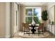 Inviting dining room with a round table, woven chairs, large windows, and elegant decor, perfect for gatherings at 1601 Goldfinch Perch Ln, Knightdale, NC 27545