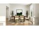 Airy dining room featuring a wooden table, comfortable seating, large windows, and plants for a refreshing feel at 1601 Goldfinch Perch Ln, Knightdale, NC 27545