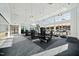 Well-equipped gym with various exercise machines, weights, and plenty of natural light at 1601 Goldfinch Perch Ln, Knightdale, NC 27545