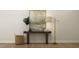 Charming hallway table with a lamp, decorative vase, and a cozy basket for added storage and style at 1601 Goldfinch Perch Ln, Knightdale, NC 27545