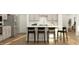 Modern kitchen with stainless steel appliances, a sleek island, and barstool seating at 1601 Goldfinch Perch Ln, Knightdale, NC 27545