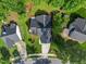 Aerial view of a cozy home featuring a well-manicured lawn and an attached two-car garage with driveway at 205 Hornholly Way, Holly Springs, NC 27540