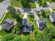 Aerial view of a cozy home featuring a well-manicured lawn and an attached two-car garage with driveway at 205 Hornholly Way, Holly Springs, NC 27540