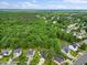 Overhead shot of homes surrounded by a canopy of green trees in a suburban neighborhood with sidewalks and manicured lawns at 205 Hornholly Way, Holly Springs, NC 27540
