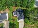 Aerial view of a cozy home featuring a well-manicured lawn and an attached two-car garage with driveway at 205 Hornholly Way, Holly Springs, NC 27540