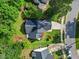 Aerial view of a cozy home featuring a well-manicured lawn and an attached two-car garage with driveway at 205 Hornholly Way, Holly Springs, NC 27540