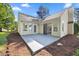 Well-maintained home featuring a concrete back patio with sliding glass door and windows at 205 Hornholly Way, Holly Springs, NC 27540