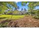 View of the backyard of this home with manicured lawn and landscaping at 205 Hornholly Way, Holly Springs, NC 27540