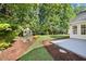 Landscaped backyard with a charming shed and well manicured lawn at 205 Hornholly Way, Holly Springs, NC 27540