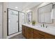 Modern bathroom featuring a double sink vanity and glass enclosed tile shower at 205 Hornholly Way, Holly Springs, NC 27540
