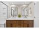 Bathroom with a double sink vanity, tiled backsplash, and modern fixtures at 205 Hornholly Way, Holly Springs, NC 27540