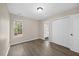 This bedroom has a closet, hardwood floors, a light, and a single window bringing in natural light at 205 Hornholly Way, Holly Springs, NC 27540