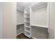 Well-organized walk-in closet with built in shelving and hardwood floors at 205 Hornholly Way, Holly Springs, NC 27540