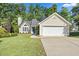 A well-maintained single-Gathering home with an attached garage and a neat front yard at 205 Hornholly Way, Holly Springs, NC 27540