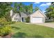 Charming home featuring a well-manicured lawn and a two-car garage at 205 Hornholly Way, Holly Springs, NC 27540