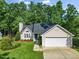 Charming single-story home featuring a well-manicured lawn and an attached two-car garage with driveway at 205 Hornholly Way, Holly Springs, NC 27540