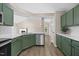 Updated kitchen with stainless steel appliances, white countertops, and stylish green cabinets at 205 Hornholly Way, Holly Springs, NC 27540