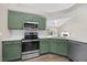 Modern kitchen featuring stainless steel appliances and green cabinets at 205 Hornholly Way, Holly Springs, NC 27540