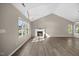 Spacious living room featuring a cozy fireplace and large windows at 205 Hornholly Way, Holly Springs, NC 27540