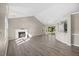 Spacious living room with hardwood floors, fireplace, and ample natural light from the backyard at 205 Hornholly Way, Holly Springs, NC 27540