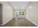 The living room has hardwood floors, lights, and a glass door with three windows bringing in natural light at 205 Hornholly Way, Holly Springs, NC 27540