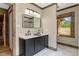 Modern bathroom features a dual sink vanity, a large mirror, and wood trim work at 2092 Winwood Farm Rd, Creedmoor, NC 27522