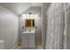 Bathroom featuring a white vanity with storage and modern fixtures, a large mirror, and a shower at 2092 Winwood Farm Rd, Creedmoor, NC 27522