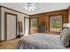 This rustic bedroom features wood walls, wood floors, and lots of natural light at 2092 Winwood Farm Rd, Creedmoor, NC 27522