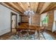 This dining room features wood ceilings, a wooden table, a chandelier, and a window to look at the outdoors at 2092 Winwood Farm Rd, Creedmoor, NC 27522