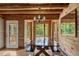The dining room features a large wood table, matching benches, and wood plank walls and ceilings at 2092 Winwood Farm Rd, Creedmoor, NC 27522